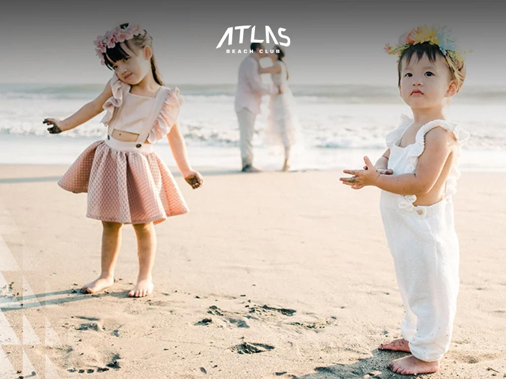 Learn tips for capturing candid family moments, including playful props, relaxed poses, and spontaneous laughter. Candid laughter during family photoshoot, Kids playing with beach toys in Bali, Family relaxing at Atlas Beach Club